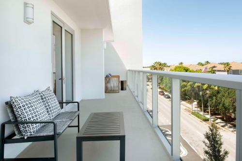 a balcony with a bench and a view of a street at Hampton Inn Delray Beach in Delray Beach
