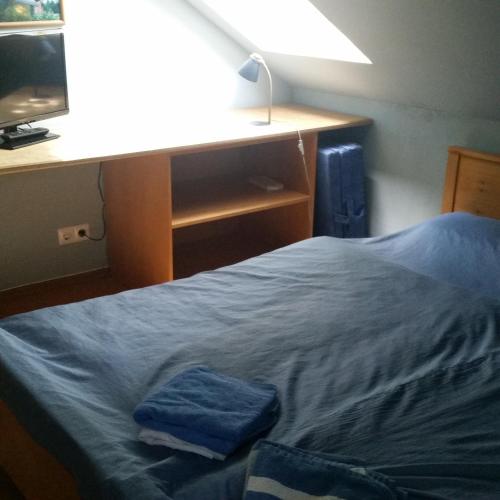 a bed with two blue towels sitting on top of it at Adelheidshof in Magelsen