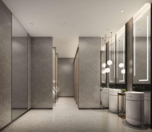 a lobby with a row of sinks and mirrors at Hilton Garden Inn Chenzhou Beihu in Chenzhou
