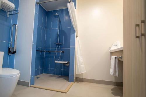 a bathroom with a shower and a toilet at Hampton By Hilton Quito La Carolina Park in Quito