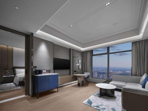 a hotel room with a bed and a tv at Doubletree By Hilton Rugao in Rugao