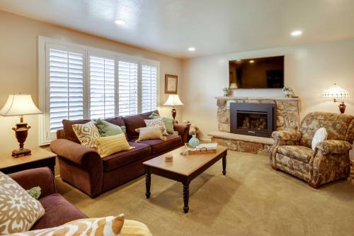a living room with a couch and a fireplace at Updated Ranch Apartment with Deck - 9 Mi to Downtown in Taylorsville