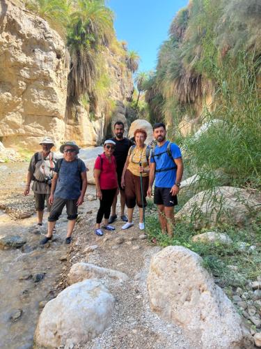 a group of people walking down a rocky trail at the old house in Kerak