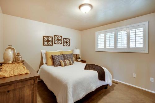 a bedroom with a bed and a window at Updated Ranch Apartment with Deck - 9 Mi to Downtown in Taylorsville