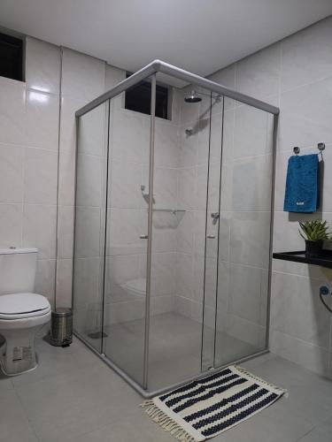 a glass shower in a bathroom with a toilet at Casa Sagrada 282 in Fortaleza