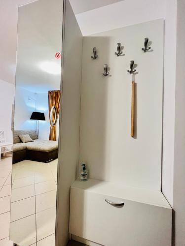 a small bathroom with a cross on the wall at Altheda Living Tiny House in Suceava
