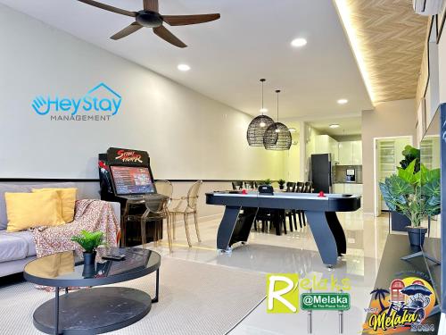 a living room with a table in the middle of a room at The Apple Residence By Heystay Management in Melaka