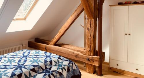 a bedroom with a wooden bed and a skylight at Ferienhof Weitblick in Letschin