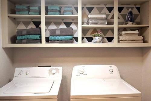 a laundry room with a white stove and towels at Lakeside Trail in Bella Vista