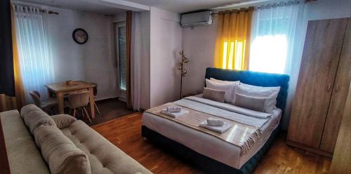 a living room with a bed and a couch at Soko City Center & Parking Free in Soko Banja