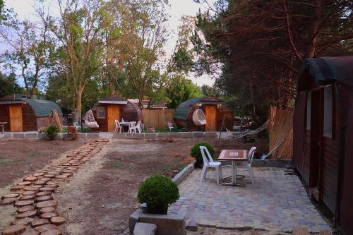 a backyard with a group of huts and a table at Pera Garden Airport Hotel in Arnavutköy
