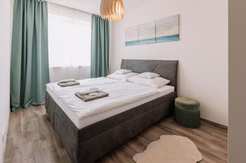 a bedroom with a large bed with white sheets at REVON Business apartment Senec in Senec