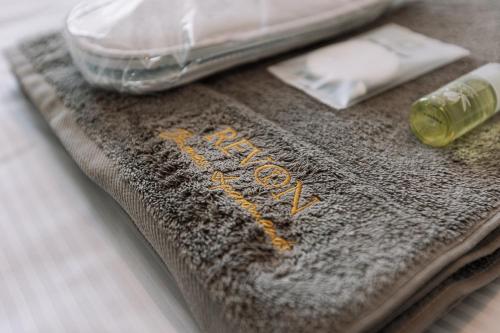 a close up of a towel with a bottle of alcohol at REVON Business apartment Senec in Senec