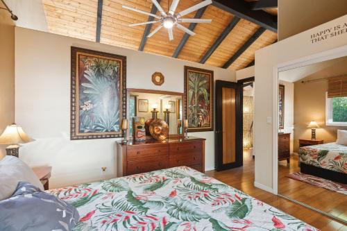 a bedroom with two beds and a ceiling fan at Pu'ukala Sunset Estate with Amazing Ocean Views! home in Kailua-Kona