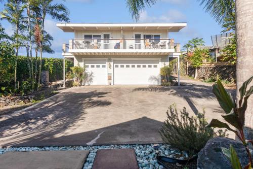 a house with a white garage and palm trees at Pu'ukala Sunset Estate with Amazing Ocean Views! home in Kailua-Kona