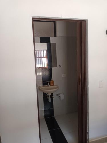 a bathroom with a sink and a mirror at Hotel Internacional Jardín in Jardin