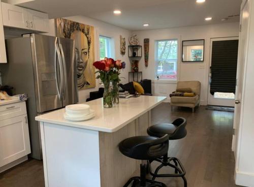 a kitchen with a counter with a vase of flowers on it at Cozy 2/1.5 Getaway in Lily Ponds in Washington, D.C.