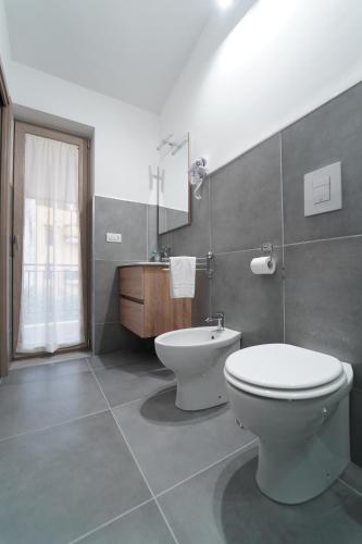 a bathroom with a toilet and a sink at Cerchia Apartments in Corbara