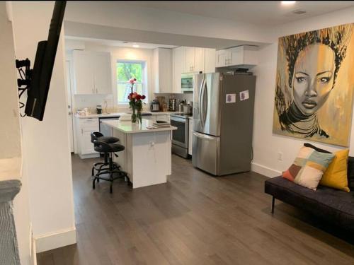 a kitchen with a refrigerator and a couch in a room at Cozy 2/1.5 Getaway in Lily Ponds in Washington, D.C.
