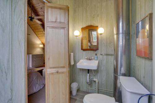 a small bathroom with a sink and a toilet at Rustic, Cozy Cabin with Easy Ski and Beach Access! in Bridgton