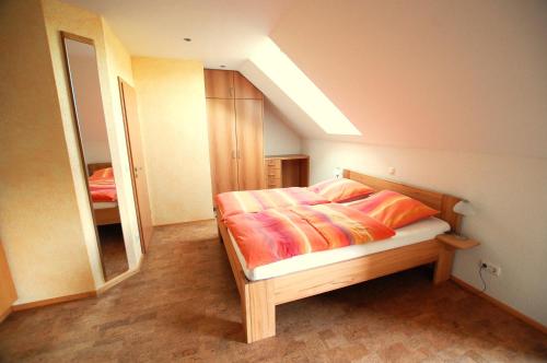 a bedroom with a bed and a large mirror at Gästehaus Jäger in Gersfeld