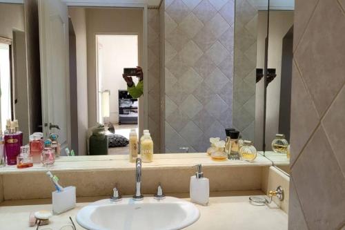 a person taking a picture of a bathroom sink at 10.000 m2 Casa de Campo Barrio de Chacra in San Andrés de Giles
