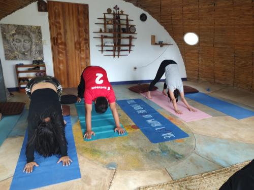 a group of people doing yoga in a room at El Encinal de las Flores in Valle de Bravo