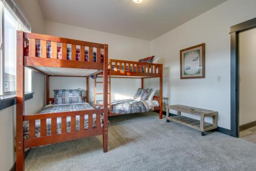 a bedroom with two bunk beds and a table at Tranquil Silverwood Estates Less Than 1 Mile to River! in Dillon