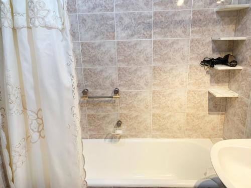 a bathroom with a shower with a white shower curtain at Administracion Callao in Buenos Aires