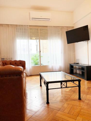 a living room with a couch and a coffee table at Administracion Callao in Buenos Aires