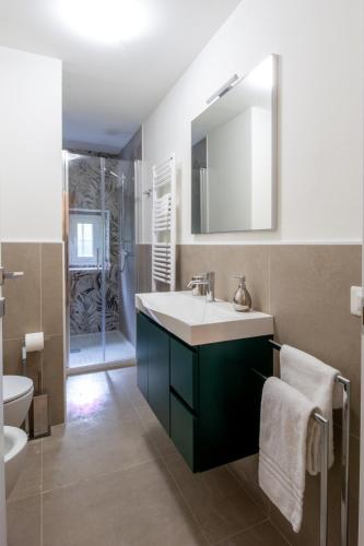 a bathroom with a sink and a toilet and a mirror at A casa di Giuly in Florence