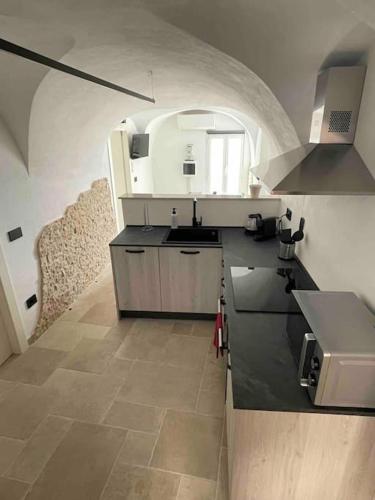 a kitchen with a sink and a counter top at Greta’s suite & private spa in Perinaldo