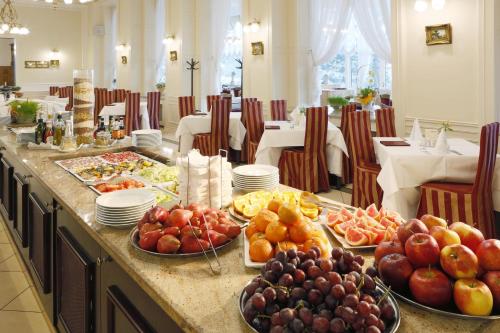 a buffet of food on a table in a restaurant at Bristol Palace in Karlovy Vary