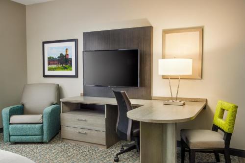 a hotel room with a desk and a tv at Candlewood Suites - Lebanon by IHG in Lebanon