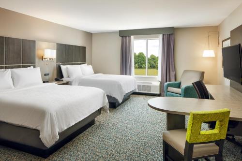 a hotel room with two beds and a table at Candlewood Suites - Lebanon by IHG in Lebanon