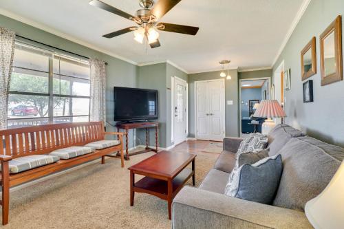 a living room with a couch and a tv at 20 Mi to Austin Texas Farmhouse on 10 Acres in Manor