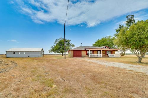 a house with a pole in the middle of a field at 20 Mi to Austin Texas Farmhouse on 10 Acres in Manor