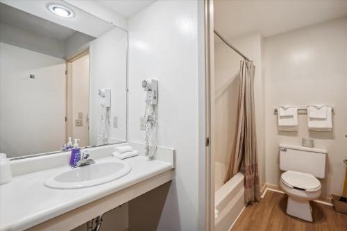 a bathroom with a sink and a toilet and a shower at Cedarbrook Standard Hotel Room 105 in Killington