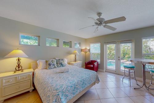 a bedroom with a bed and a ceiling fan at Coquina Sands in Holmes Beach