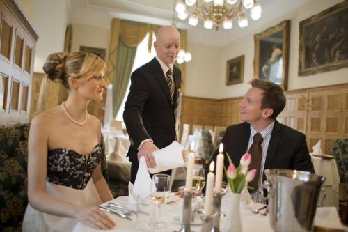 a man and a woman standing in front of a table at Bristol Palace in Karlovy Vary