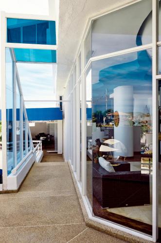 a room with a large window with a view of a building at Aquarius Hotel Boutique in Pampatar