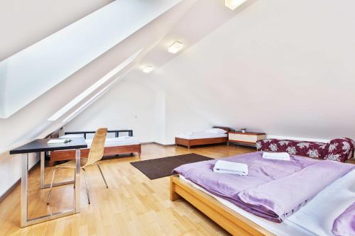 a bedroom with a bed and a desk in a attic at Dolná 4 - apartments in direct centrum on city square in Banská Bystrica