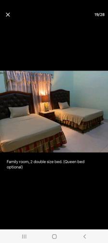 two beds sitting next to each other in a bedroom at White House by White River in Ocho Rios