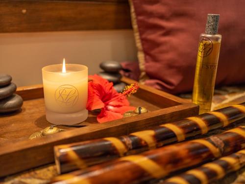 a candle sitting on a table with a wooden tray at Las Brisas Acapulco in Acapulco