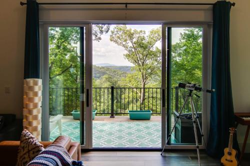 a living room with a sliding glass door leading to a deck at Modern Fairview Retreat Spacious Deck and Mtn View! in Fairview
