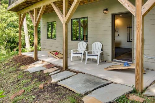a porch of a house with two chairs and a table at Modern Fairview Retreat Spacious Deck and Mtn View! in Fairview