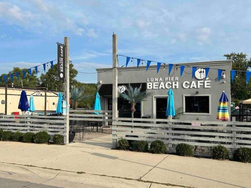 a beach cafe with blue umbrellas in front of it at Lakeside Oasis/Golf Cart/Beach in Luna Pier