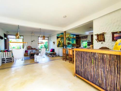 a living room with a kitchen and a bar at Maria Moñitos Hostel in Moñitos