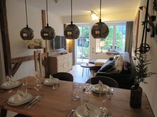 a dining room with a table with plates and glasses at Tauernlodge Sonnblick Top 2 in Mühlbach am Hochkönig