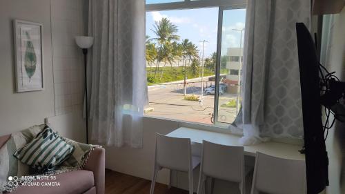 a living room with a table and a window at Estilo Bela Vista 308 in Cabedelo